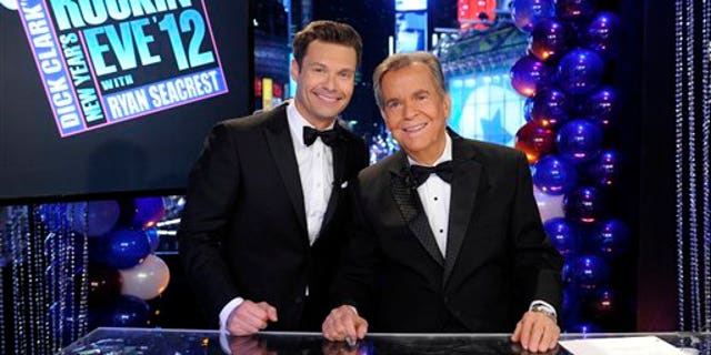 In this Dec. 31, 2011 photo released by ABC, hosts Dick Clark, right, and Ryan Seacrest pose on the set of "Dick Clark's New Year's Rockin' Eve with Ryan Seacrest 2012" in Times Square in New York. (AP Photo/ABC, Ida Mae Astute)