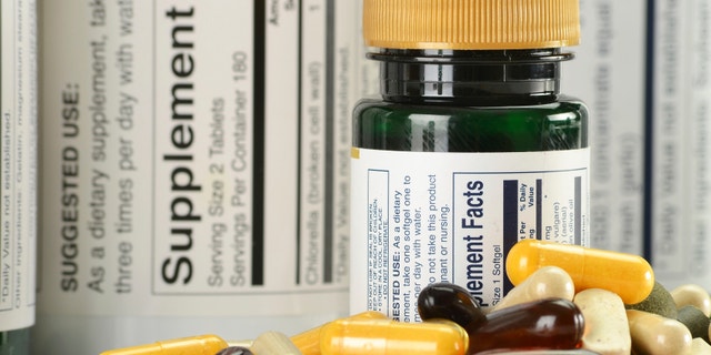 Composition with variety of dietary supplements capsules and containers