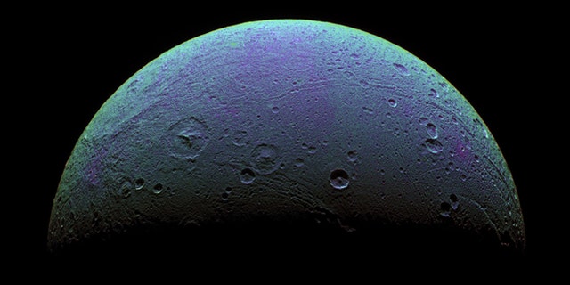 This view highlights tectonic faults and craters on Saturn's moon, Dione, an icy world that has undoubtedly experienced geologic activity since its formation. It is based on images from the the Cassini spacecraft taken on Dec. 24, 2005.