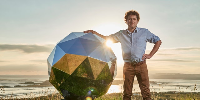 File photo - In this Nov. 2017 photo provided by Rocket Lab, Rocket Lab founder and CEO Peter Beck is pictured with his "Humanity Star" in Auckland, New Zealand. (Rocket Lab via AP)