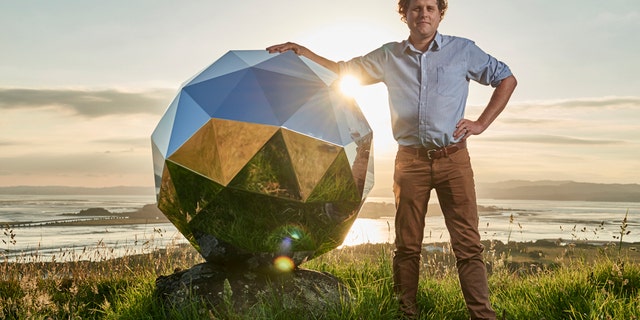 File photo - In this Nov. 2017 photo provided by Rocket Lab, Rocket Lab founder and CEO Peter Beck is pictured with his "Humanity Star" in Auckland, New Zealand. (Rocket Lab via AP)