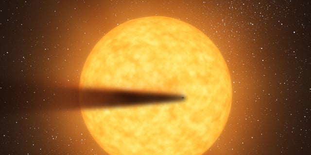 This artist's concept depicts a cometlike tail of a possible disintegrating super Mercury-size planet candidate as it transits, or crosses, its parent star, named KIC 12557548. At an orbital distance of only twice the diameter of its star, the