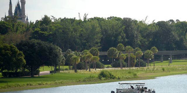 June 15: Orange County Sheriff's officers are seen searching for the boy in the Seven Seas Lagoon between Walt Disney World's Magic Kingdom theme park, left, and the Grand Floridian Resort & Spa.