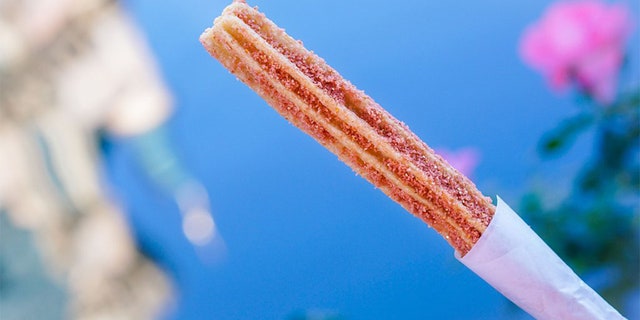 Disneyland has given rose gold fans a new treat to obsess over -- churros covered in sparkly pink-hued sugar crystals.