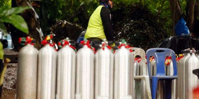 A Thai rescuer prepares oxygen tank for diving after the 12 boys and their soccer coach were found alive.