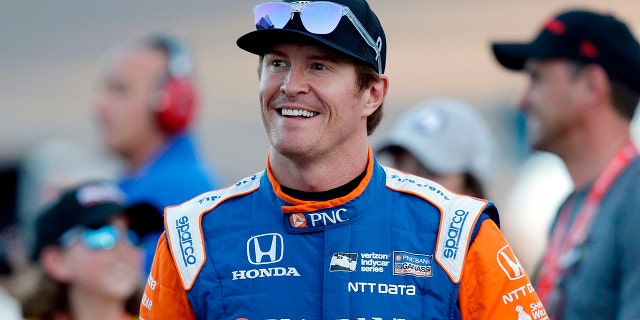 FILE - In this Saturday, April 7, 2018, file photo, driver Scott Dixon smiles before the IndyCar auto race at Phoenix International Raceway in Avondale, Ariz. Dixon will be the latest IndyCar driver to enter the realm of reality TV when he auditions in Indianapolis next week for "American Ninja Warrior. (AP Photo/Rick Scuteri, File)