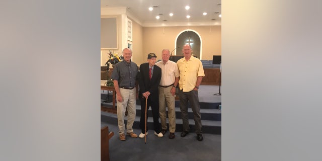 Dixon poses for a photo with his three sons.