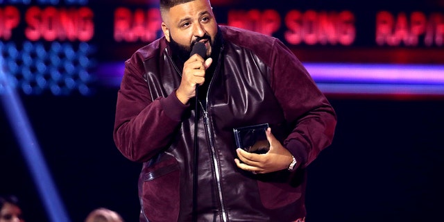 FILE - In this Sunday, Nov. 19, 2017, file photo, DJ Khaled accepts the award for favorite song rap/hip-hop for "I'm the One" at the American Music Awards at the Microsoft Theater in Los Angeles. Weight Watchers International climbed after it struck a deal with producer and recording artist DJ Khaled, who will represent the brand to millions of follows on Snapchat, Twitter, Instagram and Facebook. (Photo by Matt Sayles/Invision/AP, File)