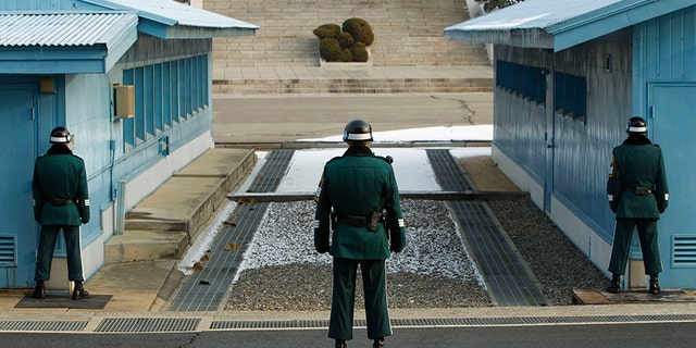 A South Korean soldier stands guard as he faces the North Korea side at the border village of Panmunjom in the demilitarized zone (DMZ) separating the two Koreas, Dec. 28, 2011.