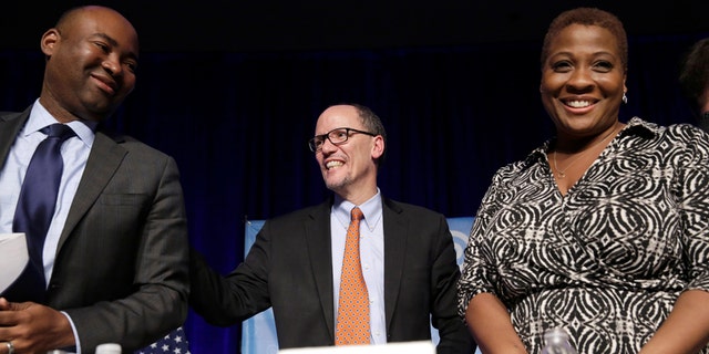 Tom Perez, center, speaks to Jamie Harrison, left, and Jehmu Green, right, in Baltimore, Maryland on February 11, 2017, during a DNC forum.