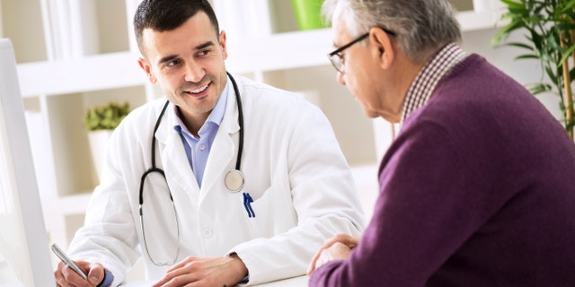 Doctor explaining prescription to senior patient, healthcare concept
