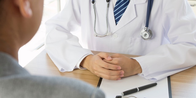 Doctor and patient sitting together. 