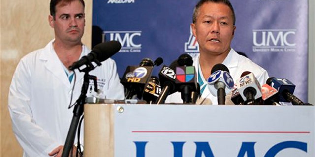 Dr. Peter Rhee, right, speaks about the condition of U.S. Rep. Gabrielle Giffords, D-Ariz., as Dr. G. Michael Lemole, Jr., looks on at University Medical Center during a news conference in Tucson, Ariz., Sunday, Jan. 9, 2011.