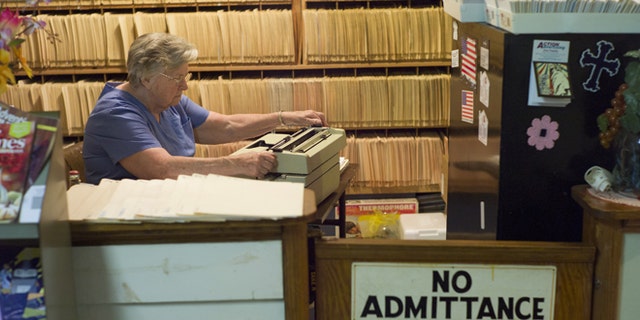 July 14, 2013: An employee is shown working in the reception and office area of a clinic in Altamont, Tenn.