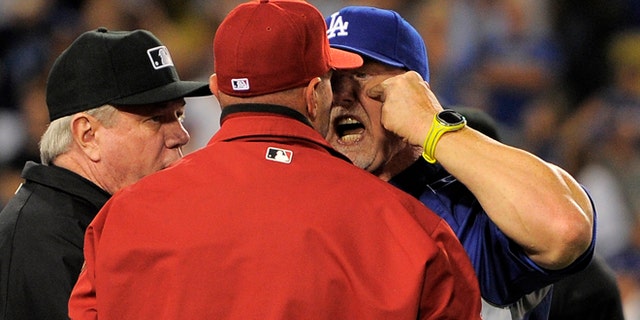 June 11, 2013: Los Angeles Dodgers batting coach Mark McGwire, right, yells at Arizona Diamondbacks manager Kirk Gibson after Los Angeles Dodgers' Zack Greinke was hit by a pitch during the seventh inning of their baseball game in Los Angeles. (AP/Mark J. Terrill)