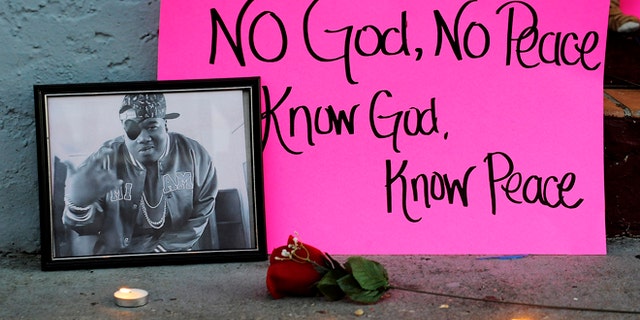 Dec. 29, 2013: A photo of slain rapper Glenn "Doe B." Thomas sits on a sidewalk Sunday, Dec. 29, 2013, at a candlelight vigil for victims of a fatal shooting at Centennial Hill Bar and Grill in Montgomery, Ala.