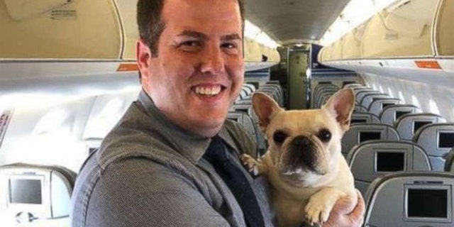 Flight attendant Renaud Fenster poses with Darcy on the Massachusetts-bound flight.