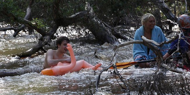 A couple had to be rescued after a ride on an inflatable doll left them stuck in the Yarra River. (Trevor Pinder/Herald Sun)