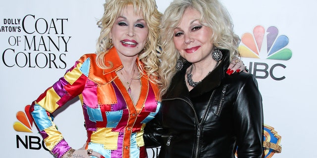 Dolly Parton (left) and Stella Parton attend the Los Angeles Premiere Of Warner Bros. Television's "Dolly Parton's Coat Of Many Colors" held at the Egyptian Theatre on December 2, 2015.