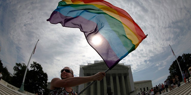 A gay marriage supporter waves a rainbow flag outside the U.S. Supreme Court in Washington on June 24, 2013. (Reuters)