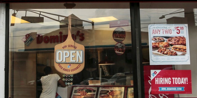 July 8, 2015: A man buys food at Domino's restaurant in Hoboken, N.J.