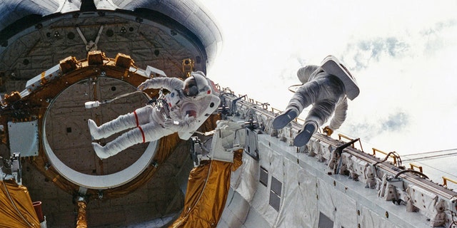 STS-6 crewmates Don Peterson (at right) and Story Musgrave perform the first shuttle-era spacewalk outside Challenger in 1983. (Credit: NASA)