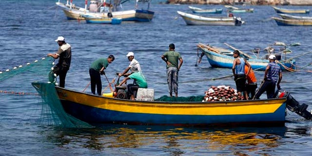 Aug. 7, 2014: In this file photo, Palestinian fishermen clean their fishnets at the fishermen's port in Gaza City. (AP)
