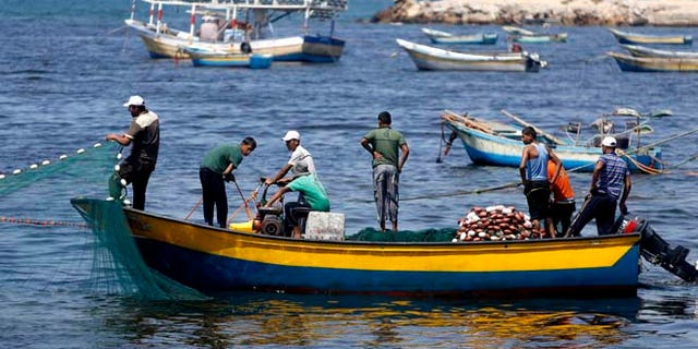 Aug. 7, 2014: In this file photo, Palestinian fishermen clean their fishnets at the fishermen's port in Gaza City. (AP)