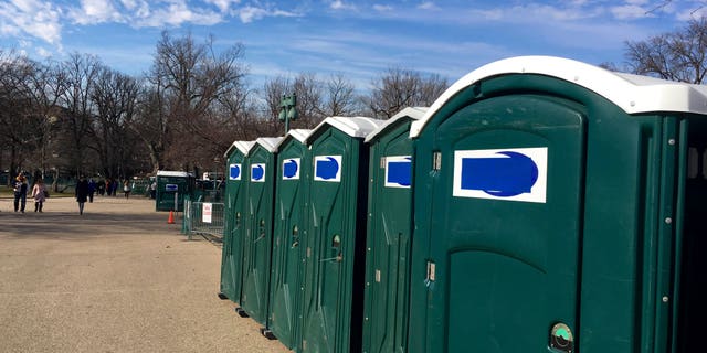 A row of portable restrooms, with the name Don's Johns covered up by blue tape, is seen on Capitol Hill in DC.