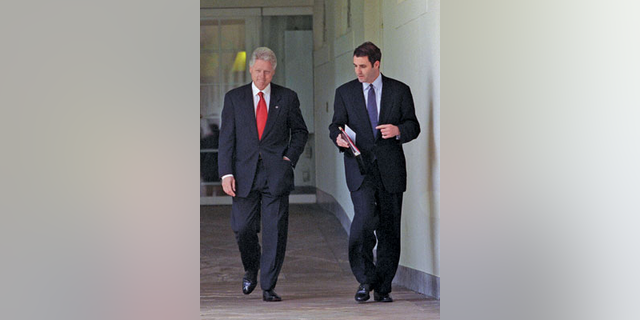 President Bill Clinton, left, walks with aide Doug Band.