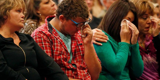 From left, Summer Smith, Mathew Downing, Lacey Scroggins and Lisa Scroggins attend a Roseburg, Ore., church service, Sunday, Oct. 4, 2015. Downing and Lacey Scroggins are survivors of the shooting at Umpqua Community College.(AP)