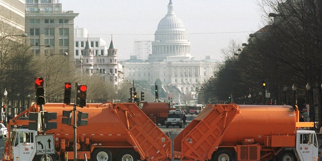 FILE: Washington, D.C. municipal garbage trucks are seen on Pennsylvania Avenue.