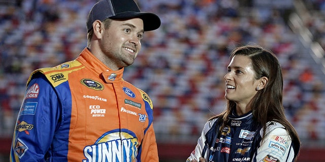 FILE - In this Oct. 6, 2016, file photo, Danica Patrick, right, talks with Ricky Stenhouse Jr, before qualifying for Saturday's NASCAR Sprint Cup series auto race at Charlotte Motor Speedway in Charlotte, N.C. Danica Patrick and Ricky Stenhouse Jr. have ended their nearly five-year relationship. A spokeswoman for Patrick confirmed to The Associated Press on Monday, Dec. 18, 2017, that the race car drivers "are no longer in a relationship." (AP Photo/Chuck Burton, File)