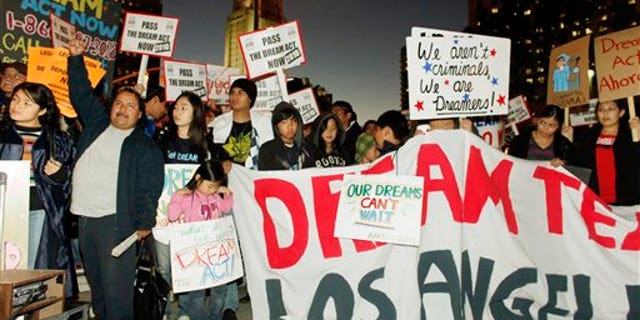 In this photo taken on Dec. 7, 2010, immigrants parents, students and others participate in a candle-light procession and vigil in support of the Federal Dream Act in downtown Los Angeles. The illegal immigrants who more than a decade ago were just teens hoping to forge a legal path to citizenship are vowing to make the Act a campaign issue come 2012, even though they'll likely be too old to benefit if the law ever passes. (AP Photo/Damian Dovarganes)