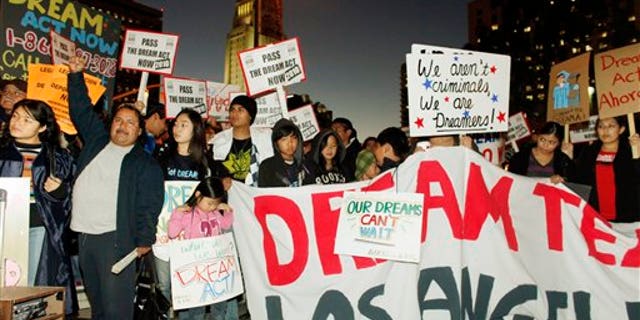 In this photo taken on Dec. 7, 2010, immigrants parents, students and others participate in a candle-light procession and vigil in support of the Federal Dream Act in downtown Los Angeles. The illegal immigrants who more than a decade ago were just teens hoping to forge a legal path to citizenship are vowing to make the Act a campaign issue come 2012, even though they'll likely be too old to benefit if the law ever passes. (AP Photo/Damian Dovarganes)