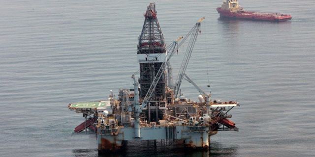 In a Tuesday, June 8, 2010 photo, a deepwater drilling rig operates near the site of the Deepwater Horizon disaster in the Gulf of Mexico. (AP)