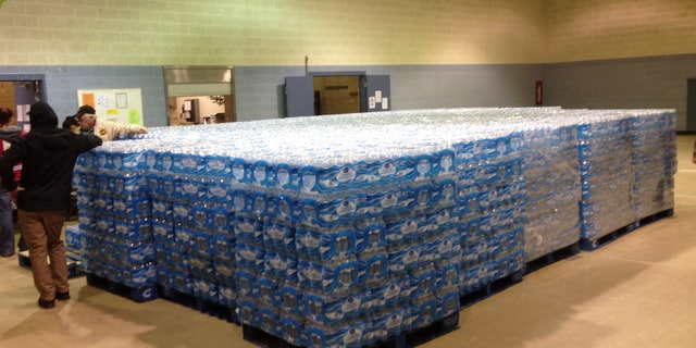 Pallets of water, ready for distribution in the community, sit at the Sebring Community Center, Tuesday, Jan. 26, 2016 in Sebring, Ohio. Authorities have been handing out bottled water, and schools were closed Tuesday for a third day in Sebring, a village about 60 miles southeast of Cleveland. The Sebring water system serves 8,100 homes and businesses in three Mahoning County communities. Testing over the weekend in Sebring found one school drinking fountain with lead levels that exceed EPA standards. (AP Photo/Mark Gillispie)