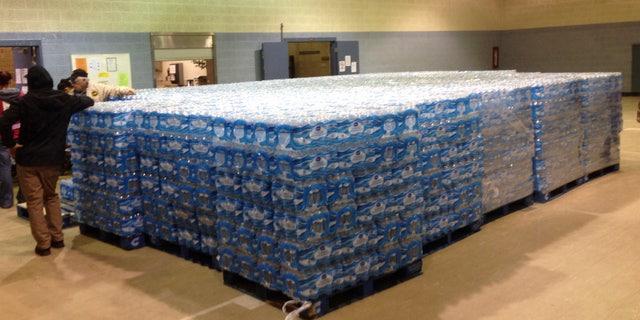 Pallets of water, ready for distribution in the community, sit at the Sebring Community Center, Tuesday, Jan. 26, 2016 in Sebring, Ohio. Authorities have been handing out bottled water, and schools were closed Tuesday for a third day in Sebring, a village about 60 miles southeast of Cleveland. The Sebring water system serves 8,100 homes and businesses in three Mahoning County communities. Testing over the weekend in Sebring found one school drinking fountain with lead levels that exceed EPA standards. (AP Photo/Mark Gillispie)