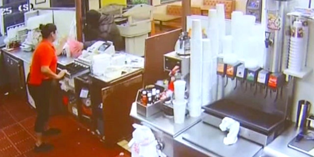 A robbery suspect was shot twice by another customer early Saturday morning.