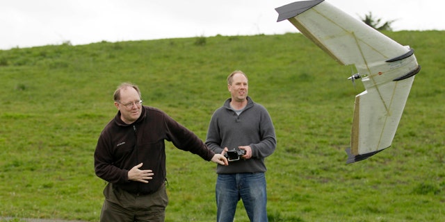 March, 28, 2012: Mark Harrison, left, and Andreas Oesterer, right, watch as a Ritewing Zephyr II drone lifts off at a waterfront park in Berkeley, Calif.