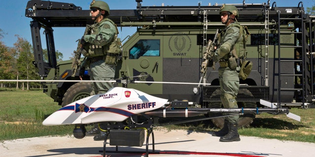 This Sept. 2011 photo provided by Vanguard Defense Industries, shows a ShadowHawk drone with Montgomery County, Texas, SWAT team members.