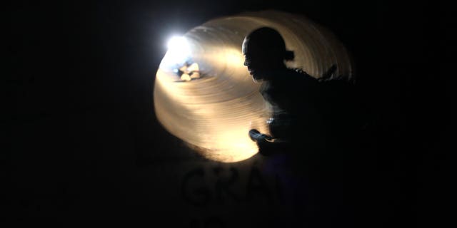 (FILE PHOTO) U.S. Border Patrol agent Colleen Agle searches for evidence of drug smugglers in a drainage tunnel that runs under the U.S.- Mexico border on December 7, 2010 in Nogales, Arizona.  (Photo by John Moore/Getty Images)