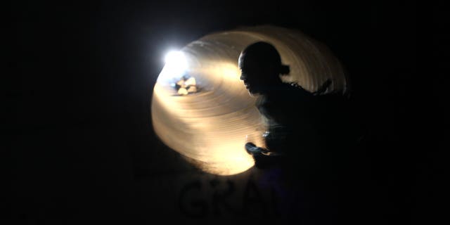 (FILE PHOTO) U.S. Border Patrol agent Colleen Agle searches for evidence of drug smugglers in a drainage tunnel that runs under the U.S.- Mexico border on December 7, 2010 in Nogales, Arizona. (Photo by John Moore/Getty Images)