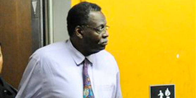 Dr. Tyron Reece, a general practitioner who runs a solo practice is taken into custody by law enforcement personnel at his office in Inglewood, Calif., on Aug. 16, 2011.