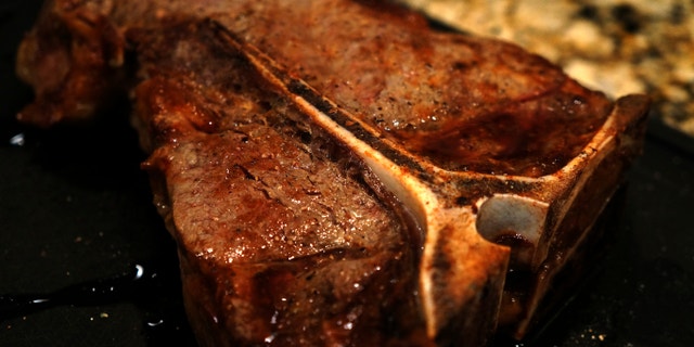T-Bone Steak is grilled to perfection with mushrooms.