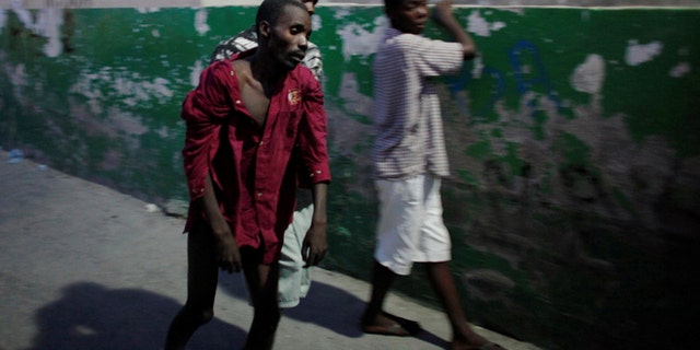 FILE 2010: A Haitian with cholera arrives to receive treatment at St-Catherine hospital in the slum of Cite-Soleil in Port-au-Prince
