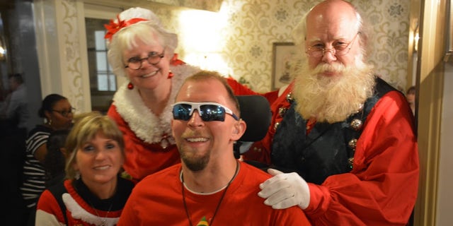 One severely wounded veteran was able to take his photo with Mr. and Mrs. Claus at the Wounded Warrior Project-Pfizer event in Ohio.