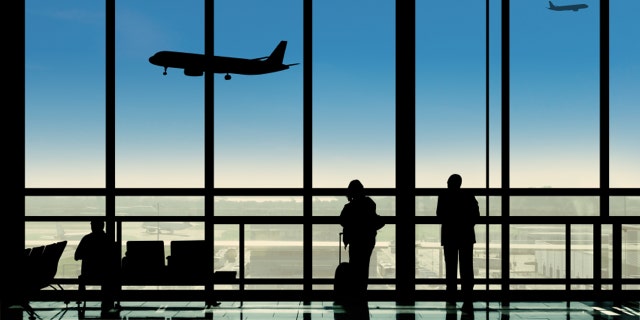Waiting in the airport terminal watching planes