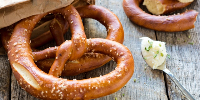 Fresh baked pretzel and cream cheese.Selective focus on the pretzel
