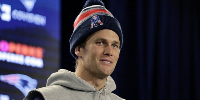 In this undated photo, Tom Brady takes questions from the media at Gillette Stadium in Foxboro, Mass.